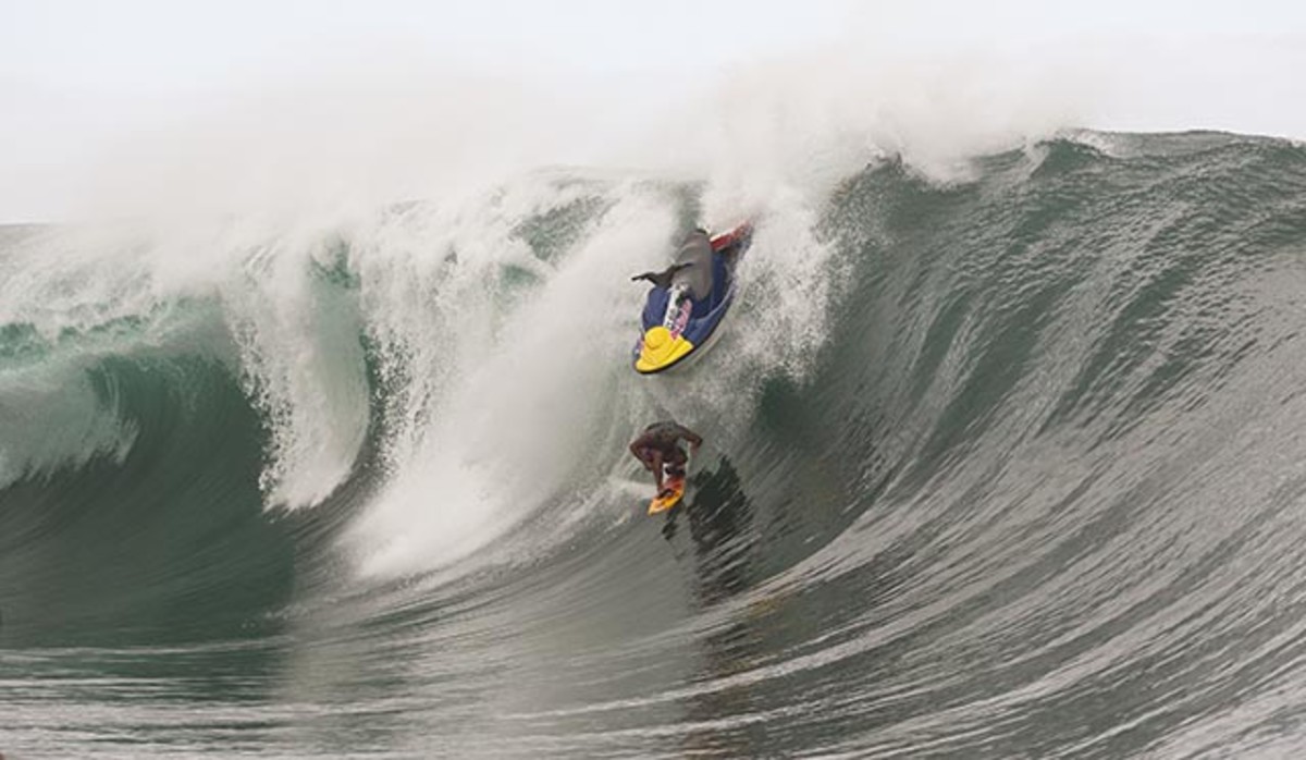 Raimana Van Bastoaler barely dodges a jet ski that was vacated by his tow-in partner Reef McIntosh; photo by Brian Bielmann