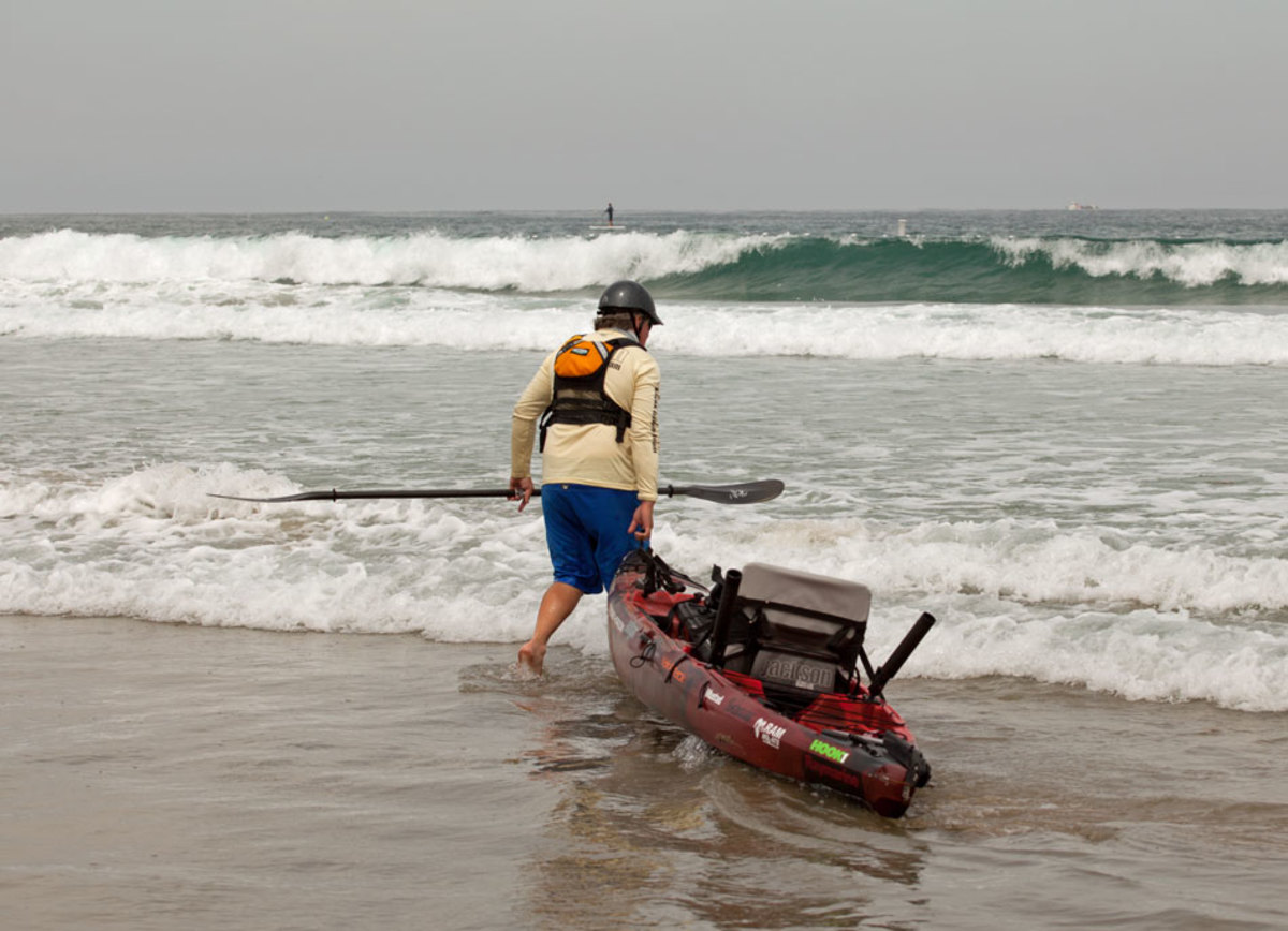 Jim Sammons has been watching the surf as he sets up his boat. He's looking for the pattern, and watching for lulls.