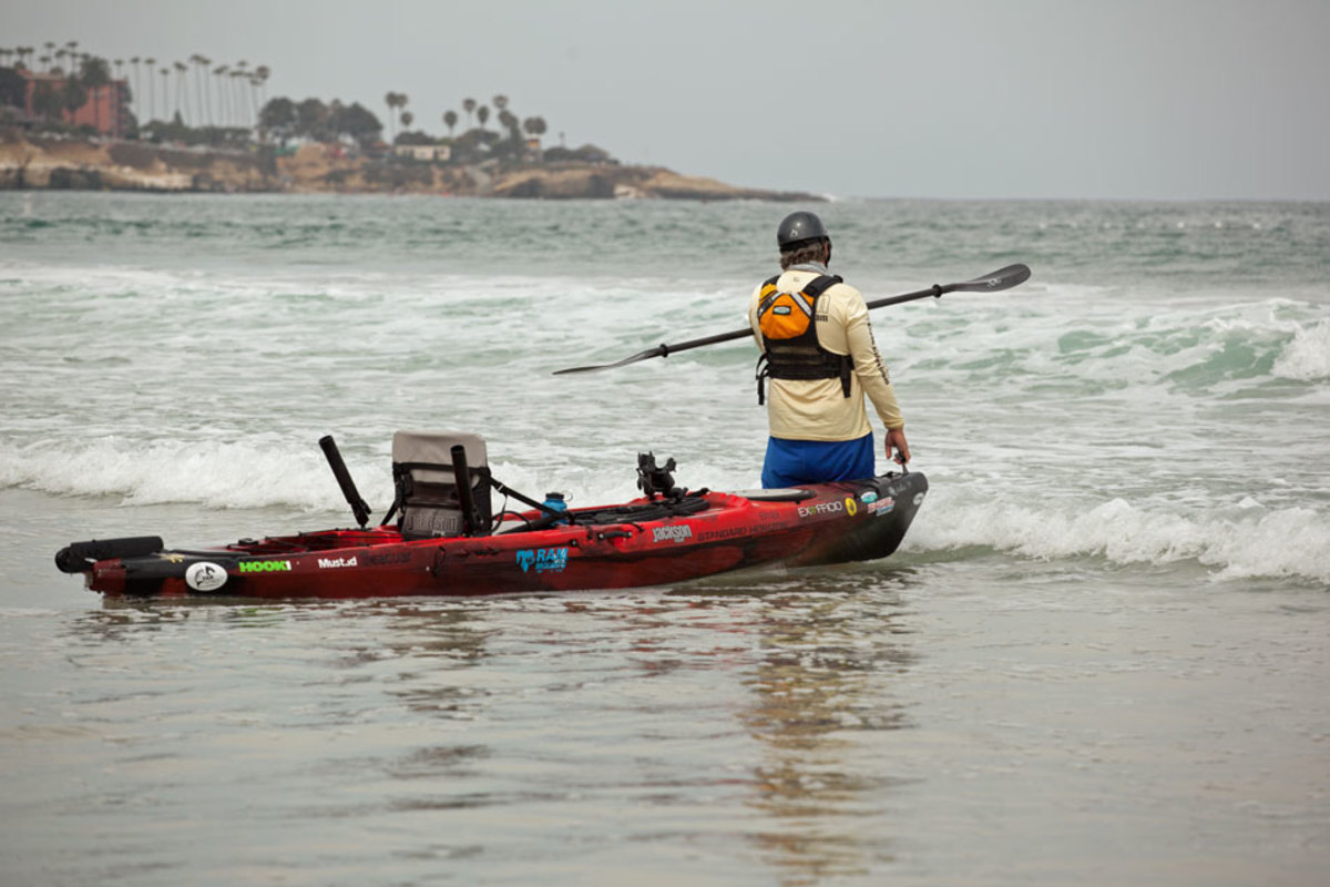 JIm wades out to knee deep water, ready to hop on and go, go, go when he spots a lull in the waves - usually right after the set swell breaks.