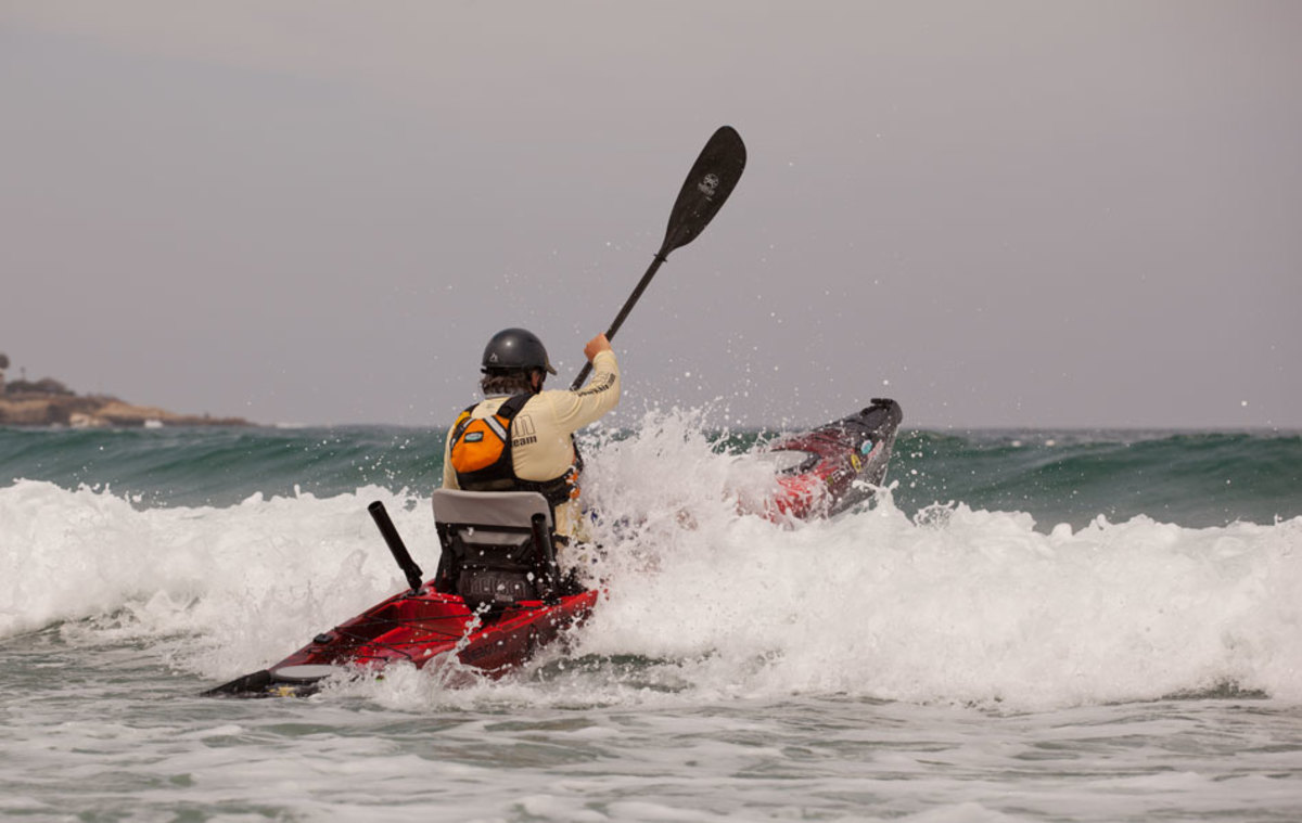 Now that he's committed, there's no stopping or hesitation. Jim plants his paddle and powers through oncoming waves.