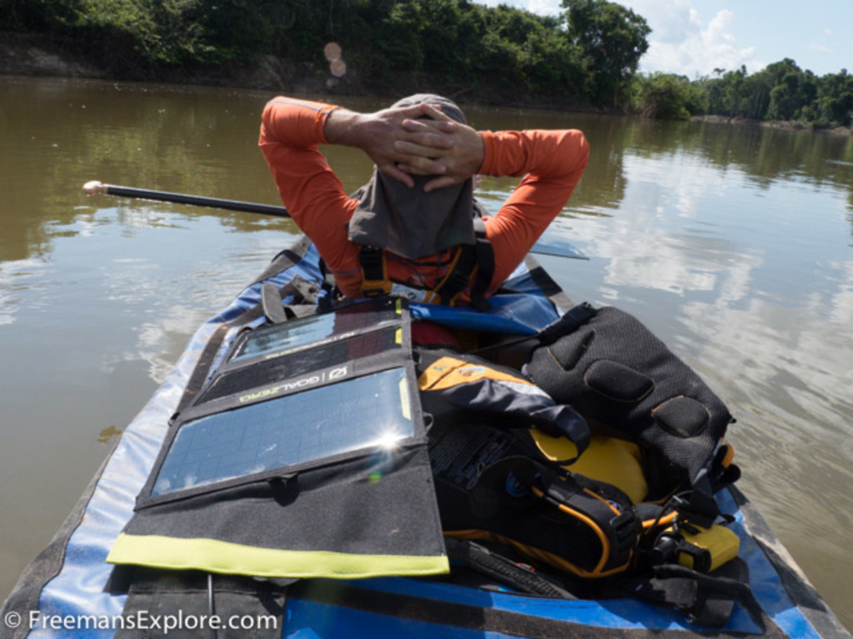Paul Schurke soaks up the sun along with one of the team's solar panels during a brief rest on the Rio Roosevelt. The team used GoalZero solar panels and battery packs to power all of their cameras and communication equipment during their five weeks on the river. Photo Dave Freeman