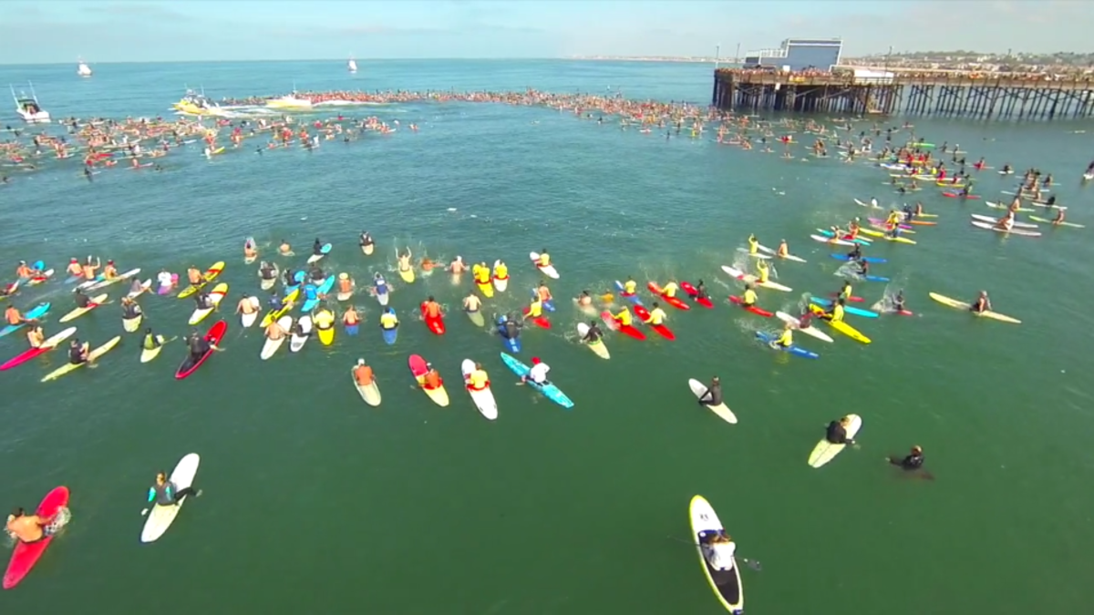 Lifeguard Ben Carlson is honored with one of the largest paddle-out memorials in Orange County history. Photo is a screen grab from video by EP5 Productions