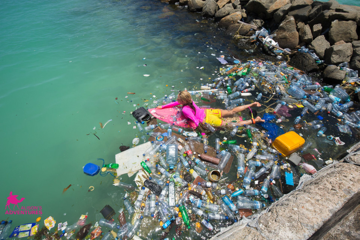 Alison Teal paddles through piles of trash