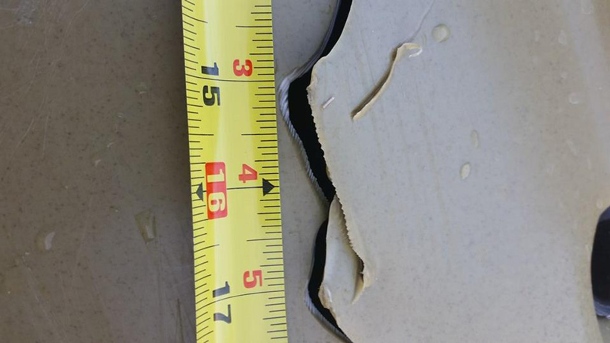 The shark left a deep cut more than six inches long in the hull of Howell's kayak just under the cockpit. The damage was severe enough to flood the boat within minutes. Photo courtesy Ryan Howell, Central Coast Kayak Fishing.