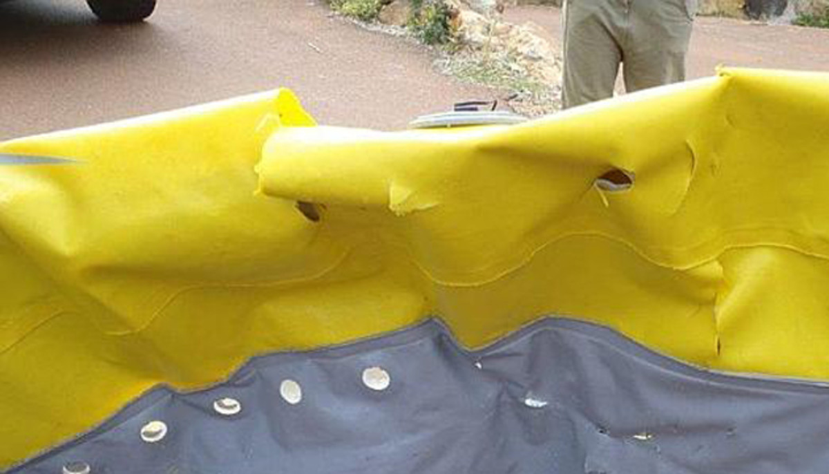 Holy moly. Two men fishing aboard an inflatable kayak off Perth, Australia experienced the scare of their lives when a shark popped their humble boat. Photo: Western Australia Police.