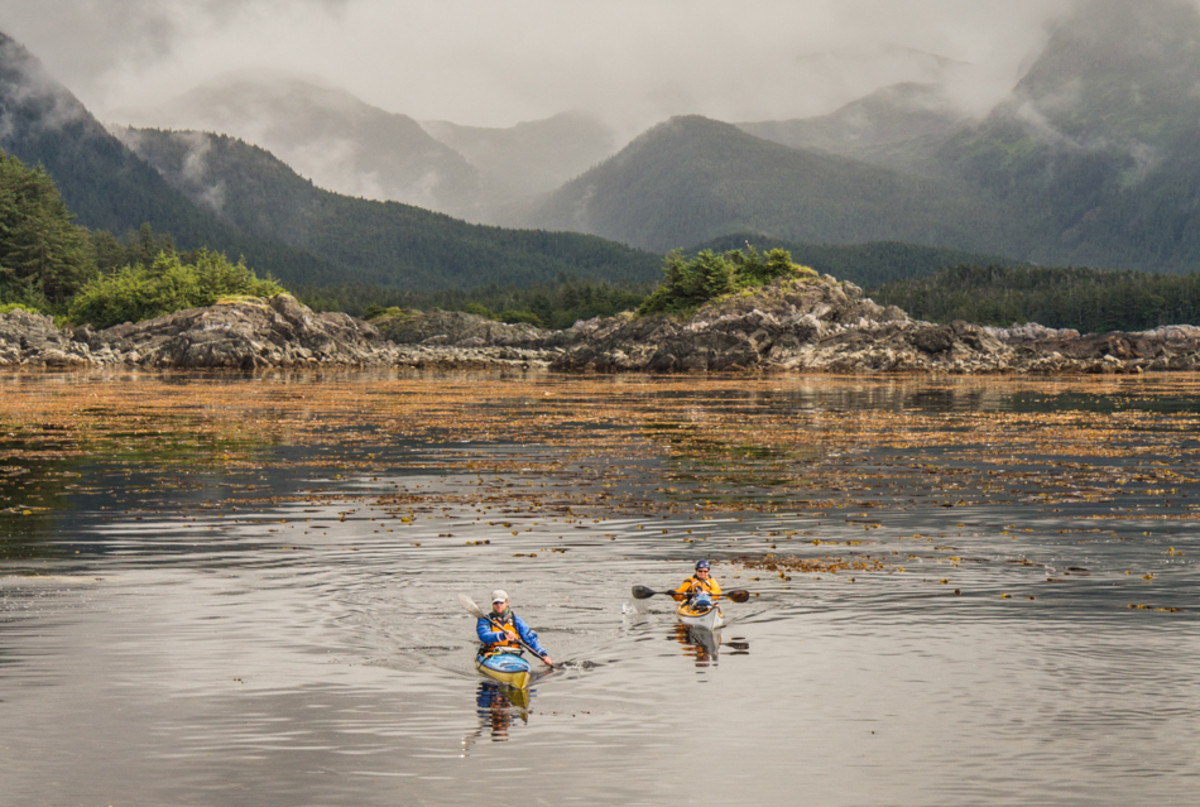 Paddlers Nathaniel Stephens and Debbie Hingst. Photo taken from higher ground during the a paddle from Sitka to Hoonah, around Chichagof Island