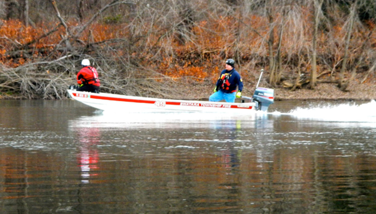 A search party runs the river looking for a missing 17-year-old. Jeff Little photo.