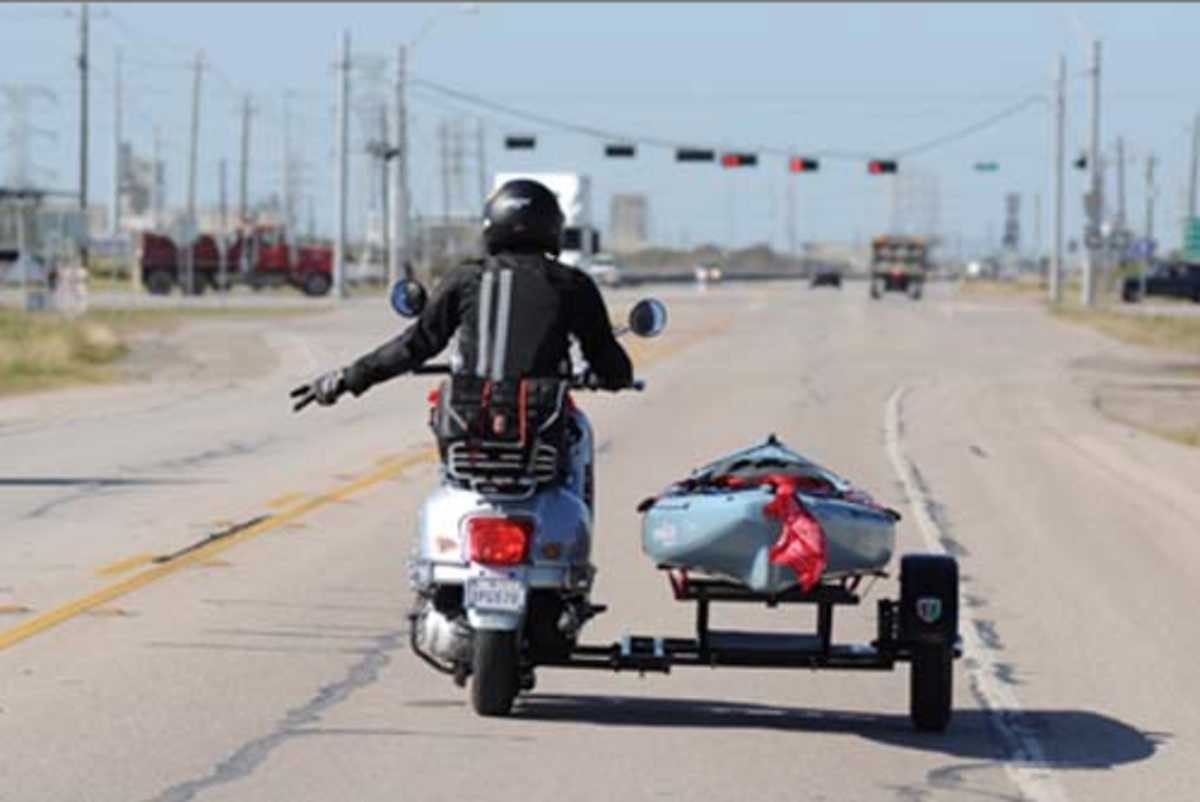 Jeff Herman and his kayak fishing Vespa, somewhere in Texas