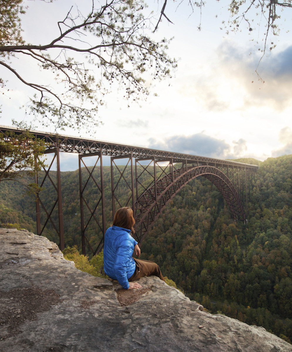 fayetteville Kaare Iverson sits at the edge of Bridge Buttress in New River Gorge, West Virginia and enjoys a sunset over the longest arch bridge in North America. Photo: Kaare Iverson / Tandem Stock