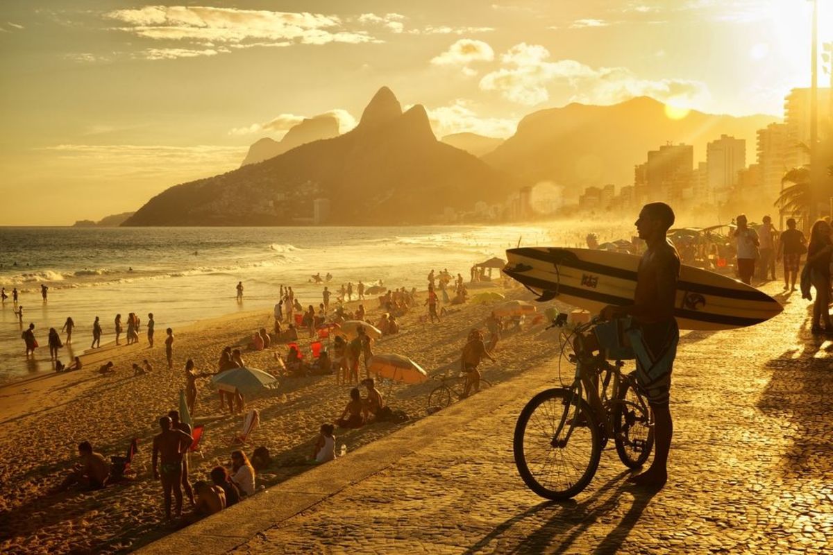 A surfer surveys the waves at Copacabana. Photo Jefferson Bernardes / Shutterstock.com