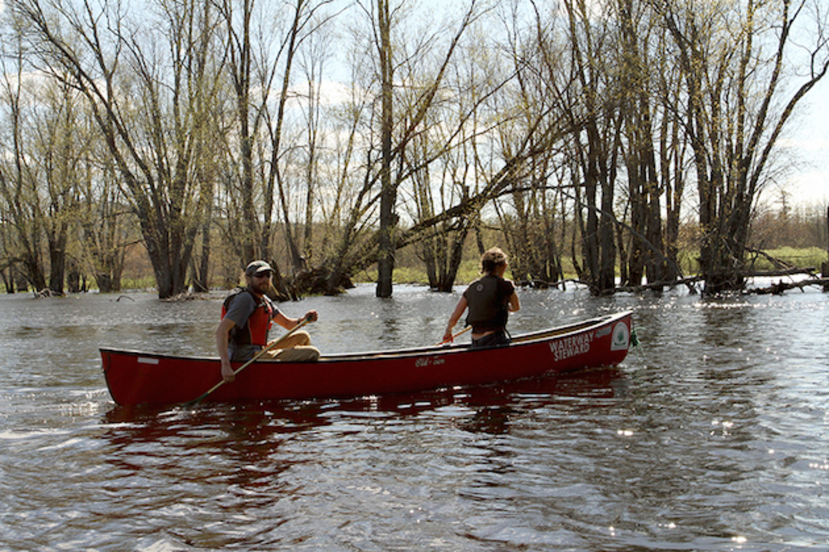 Northern Forest Canoe Trail regional stewardship director Noah Pollock paddles with NFCT director Karrie Thomas on the Saranac River.