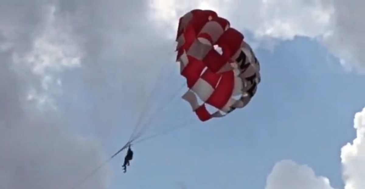 Two Brits parasailing in Malta get swept away by high winds after rope snapped. Photo: Screen grab