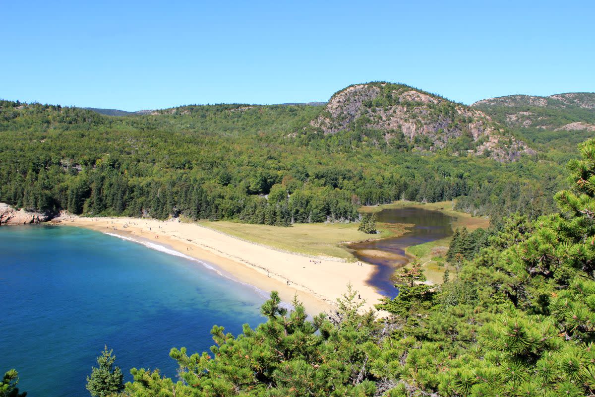 The Beehive—where you'll find a steep ladder-and-rung hike—looms behind Sand Beach. Photo: Johnie Gall.