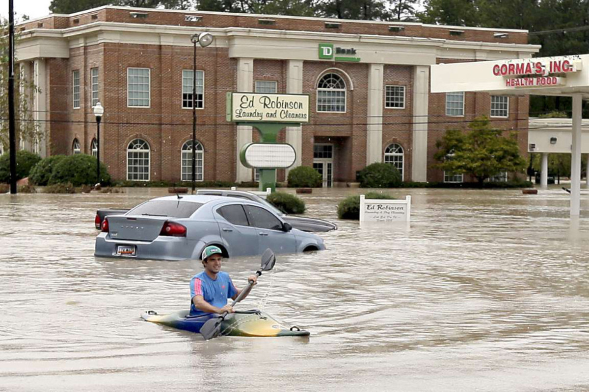 Jordan Bennett exploring flooded Columbia, SC. Photo Chuck Burton AP