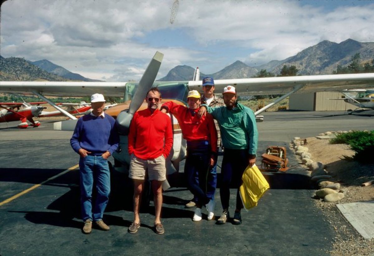 Doug Tompkins, Royal Robbins, Reg Lake, and pilot Jeff Jones about to take off for the South Fork of the Kern, 75 miles of unrun river starting at 9,100 feet. Tompkins removed the seats in the plane to fit bodies and kayaks.