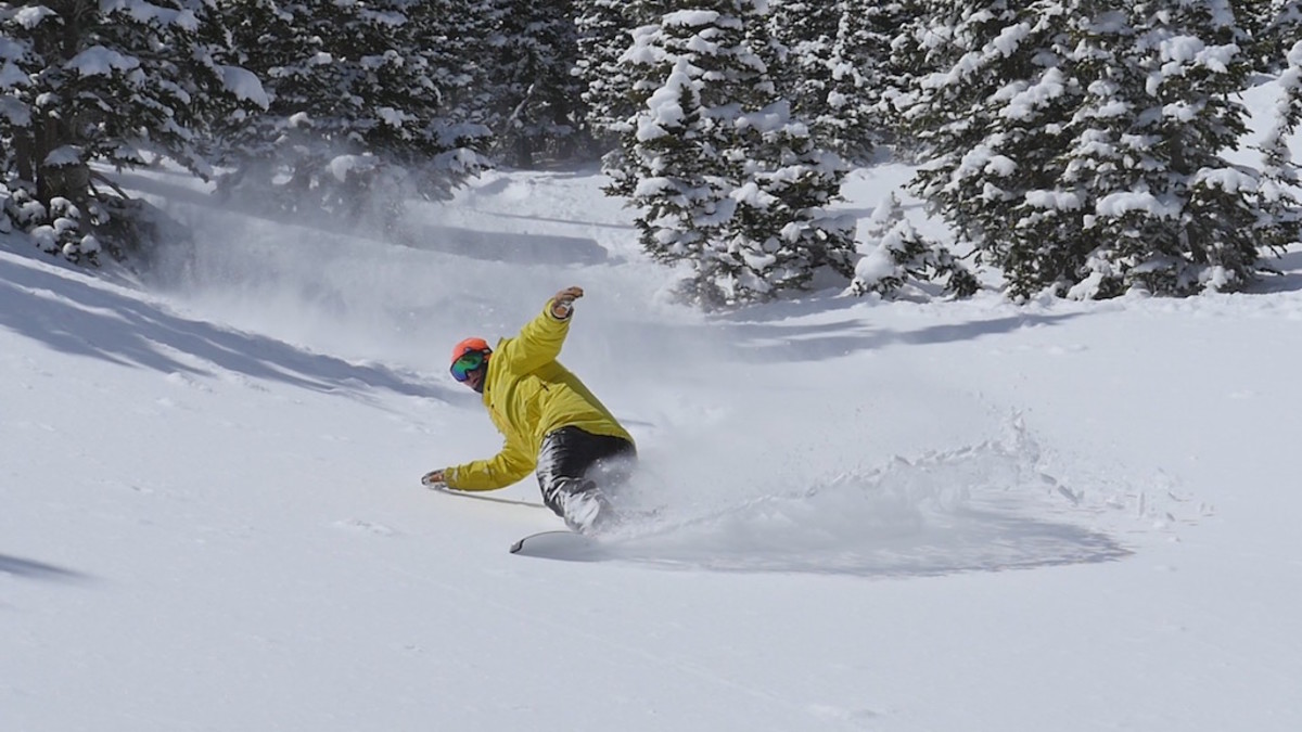 Never Summer snowboarder in powder