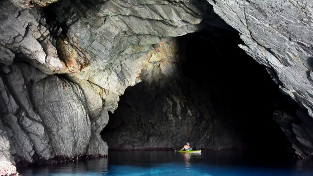 Exploring the caves of Corsica's coast. Image from "Girls Go Round."