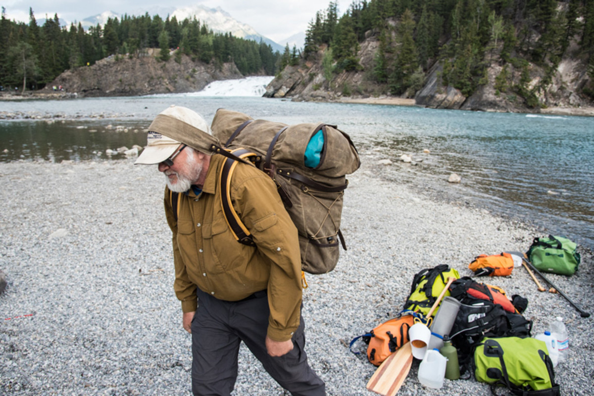 Alan Schmidt uses the padded tump line on the Frost River Grand Portage pack during a canoe trip in Alberta, Canada. Photo by Aaron Schmidt