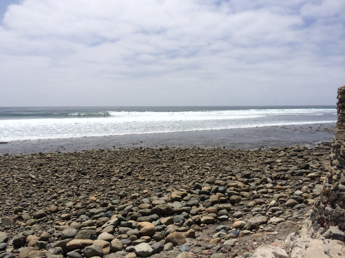 The surfer with the helmet dropping in on a set wave at K38. Photo: Courtesy of Cyrus Saatsaz