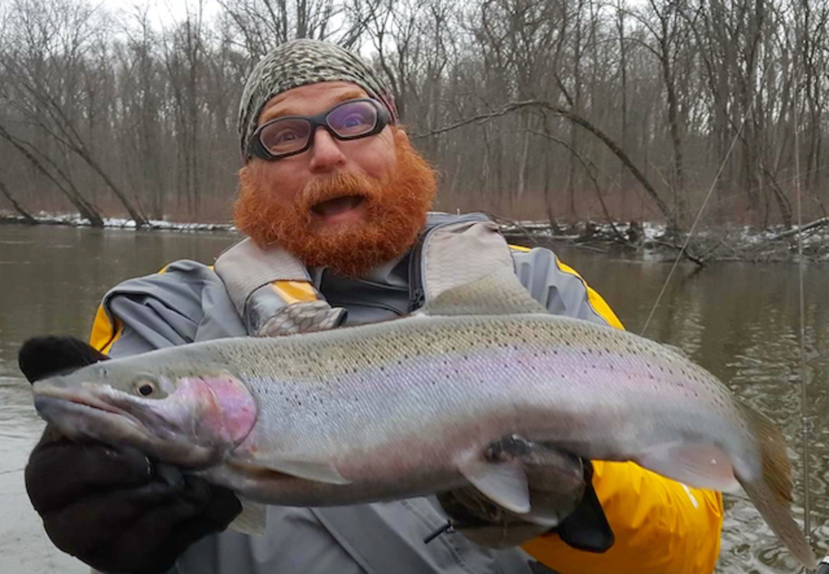 Safely packaged in his dry suit, our Viking correspondent shows off his steelhead. Photo Dave Mull