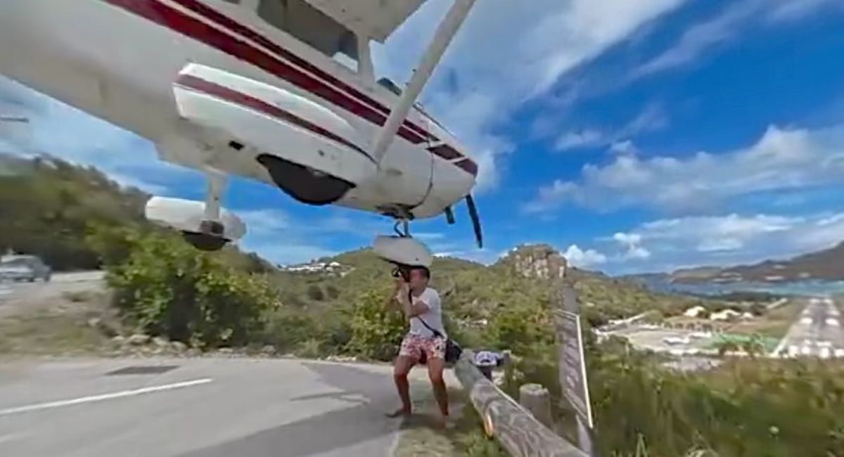 Tourist is grazed on right hand by the tire of landing aircraft at Gustaff III Airport.