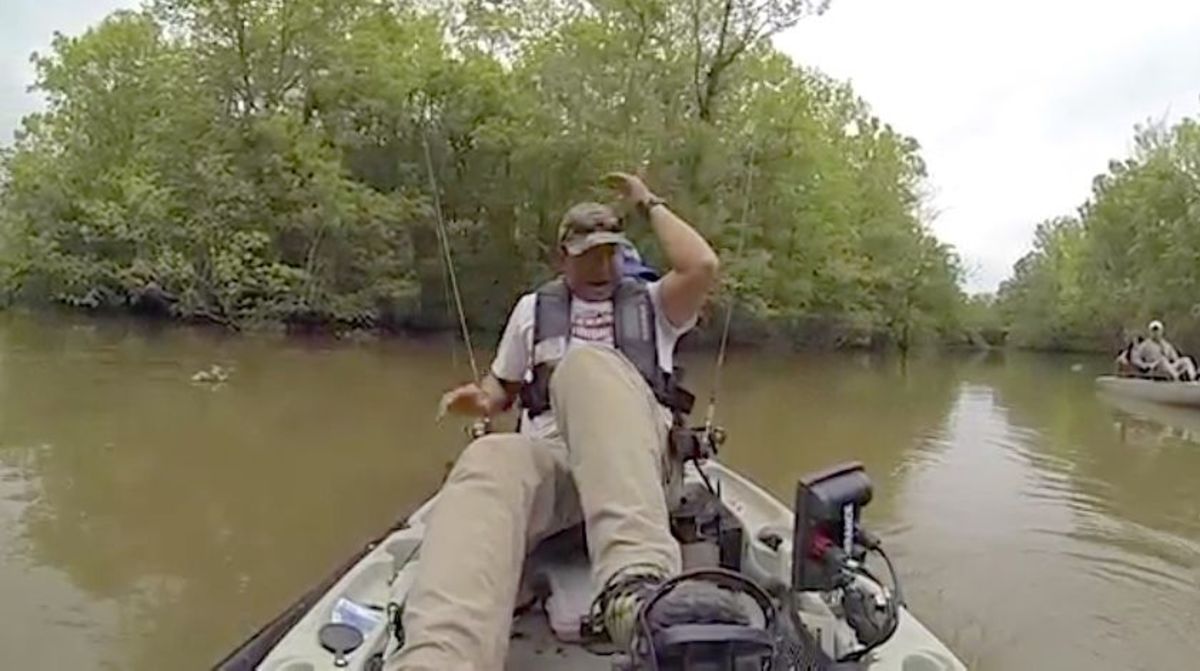 Lance Burgos reacts after pulling in a jug line and seeing the massive jaws of a huge alligator.