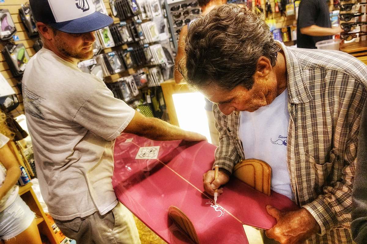 Steve Lis signs one of his own creations. Photo by Joe Ryan