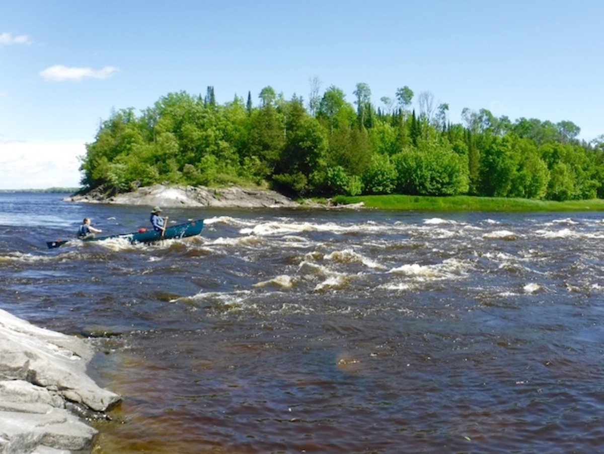 Tessa (bow) and Chelsea (stern) on of our first sets of rapids along the Rainy River.