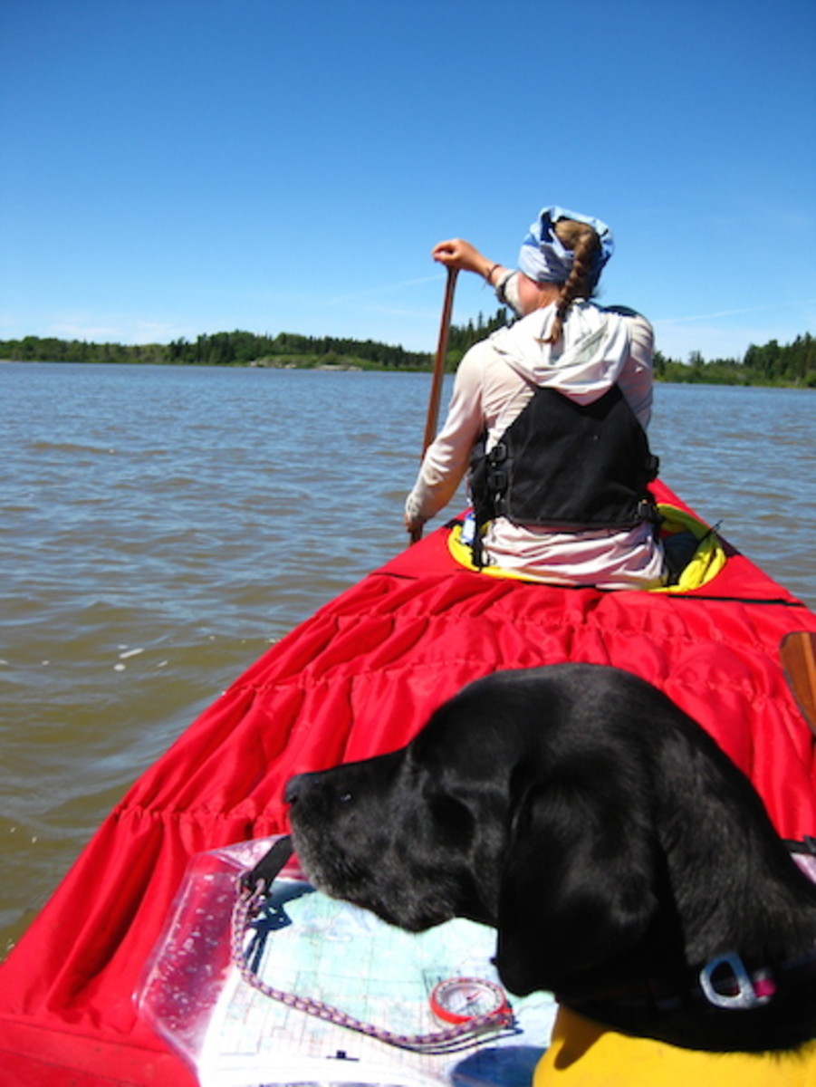 Whitney and Avery on Lake Winnipeg with canoe covers on.