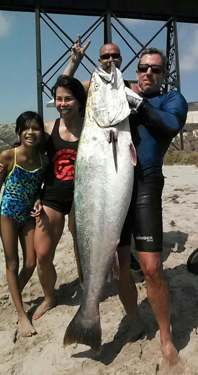 Phil and friends celebrate the catch of his tanker seabass on the beach at Gaviota. Photo courtesy Phil Morreale