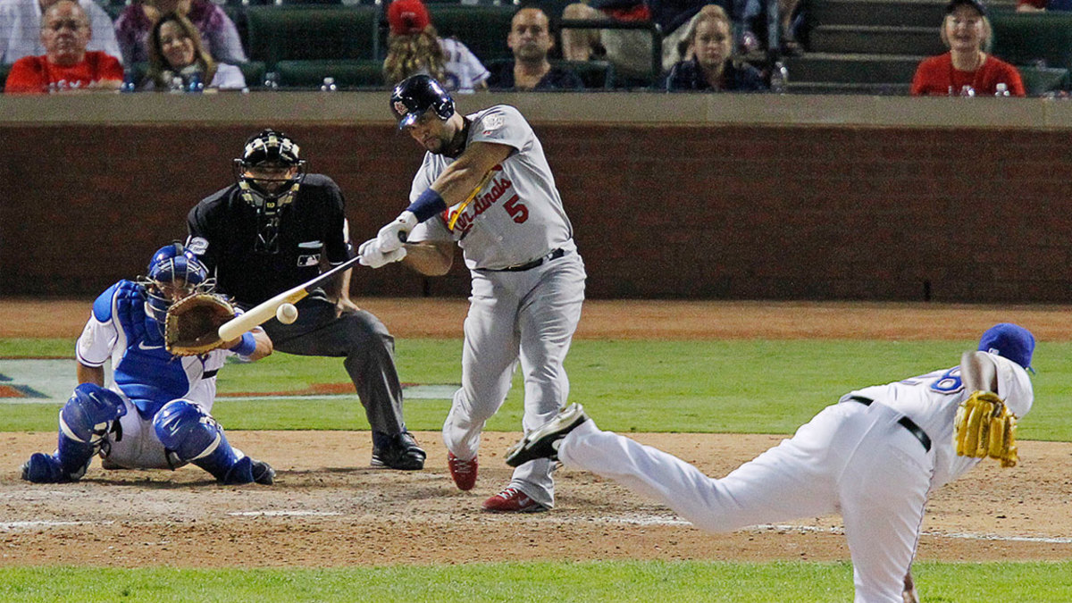 St. Louis Cardinals' Albert Pujols (5) hits a solo home run in the ninth inning off of Texas Rangers relief pitcher Darren Oliver, his third home run in Game 3 of the World Series at Rangers Ballpark in Arlington on Saturday, October 22, 2011, in Arlington, Texas. The Cardinals took a 2-1 series lead with a 16-7 victory. (Rodger Mallison/Fort Worth Star-Telegram/MCT via Getty Images)