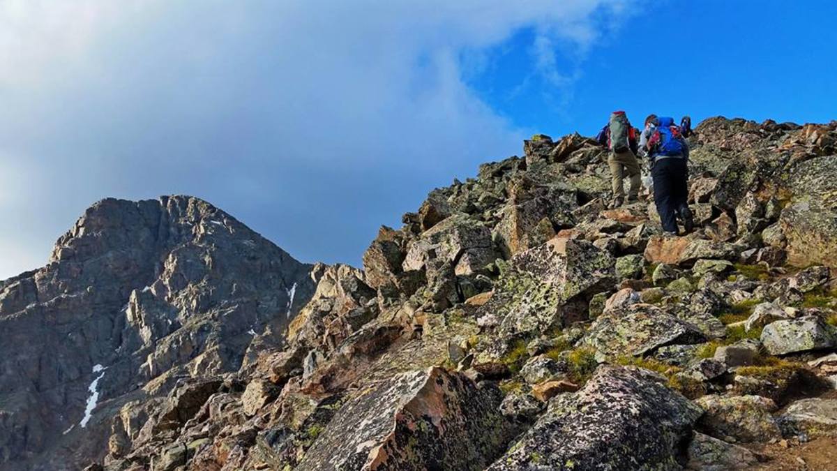 Two hikers heading up the north ridge line to reach the summit of Mount of the Holy Cross.