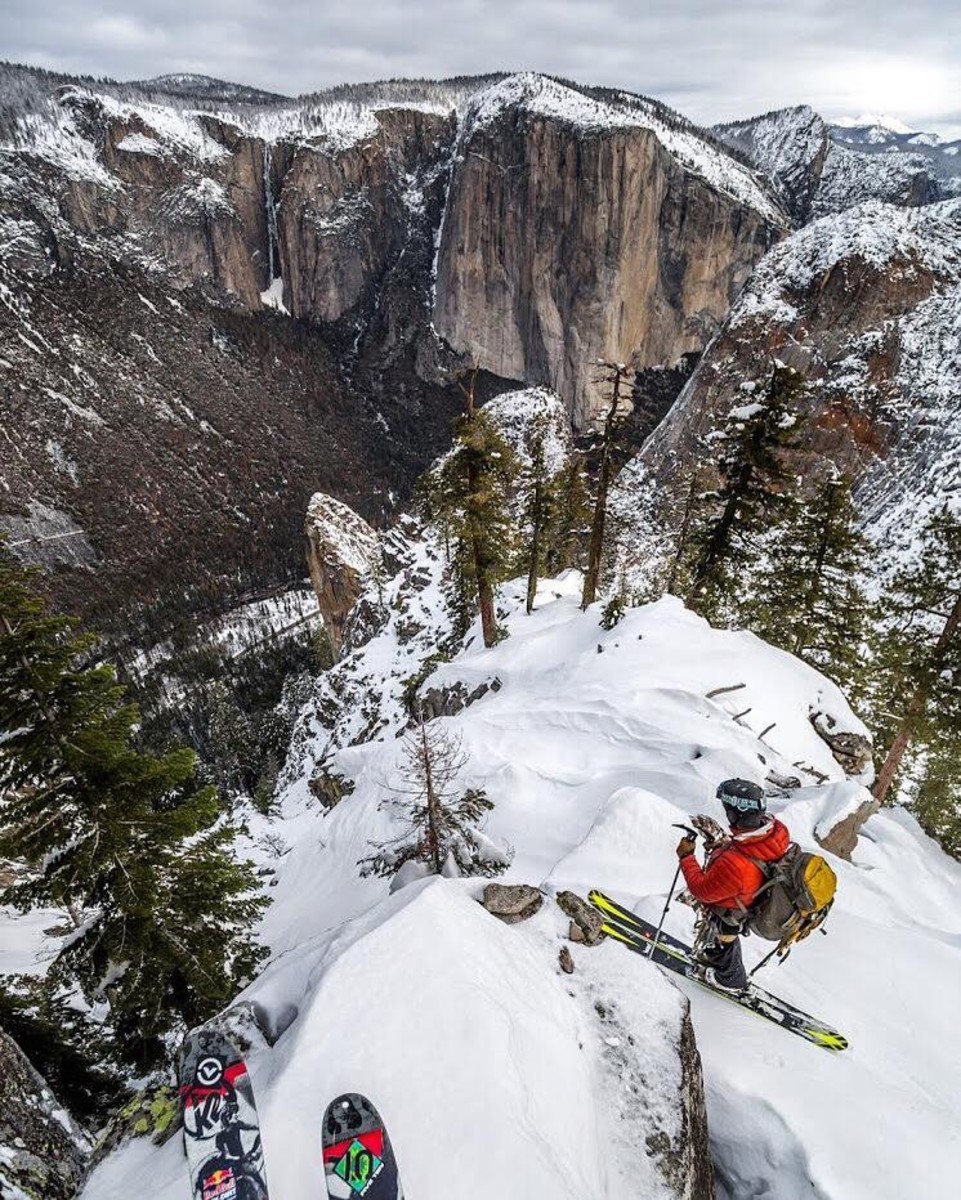 The tips of Eric Rasmussen's skis and Jason Torlano backcountry skiing in Yosemite Valley. The 3,000 foot face of El Capitan is in the distance. Photo courtesy of Eric Rasmussen