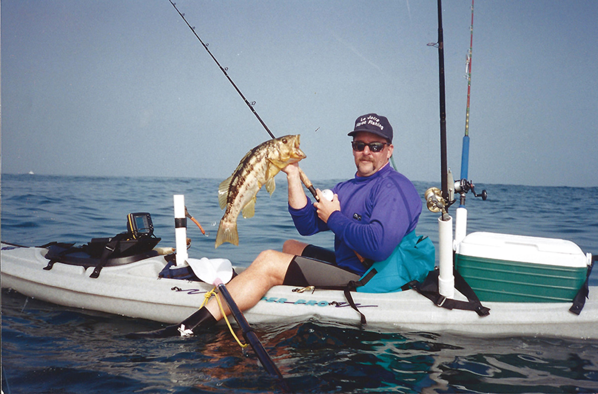 Jim Sammons aboard his Ocean Kayak Scupper Pro TW in the early 1990s -- complete with PVC rocket launcher rod holders, a live bait tank crafted from a plastic tub, and a portable fish finder. The evolution of the modern fishing kayak was well underway. Jim Sammons photo.
