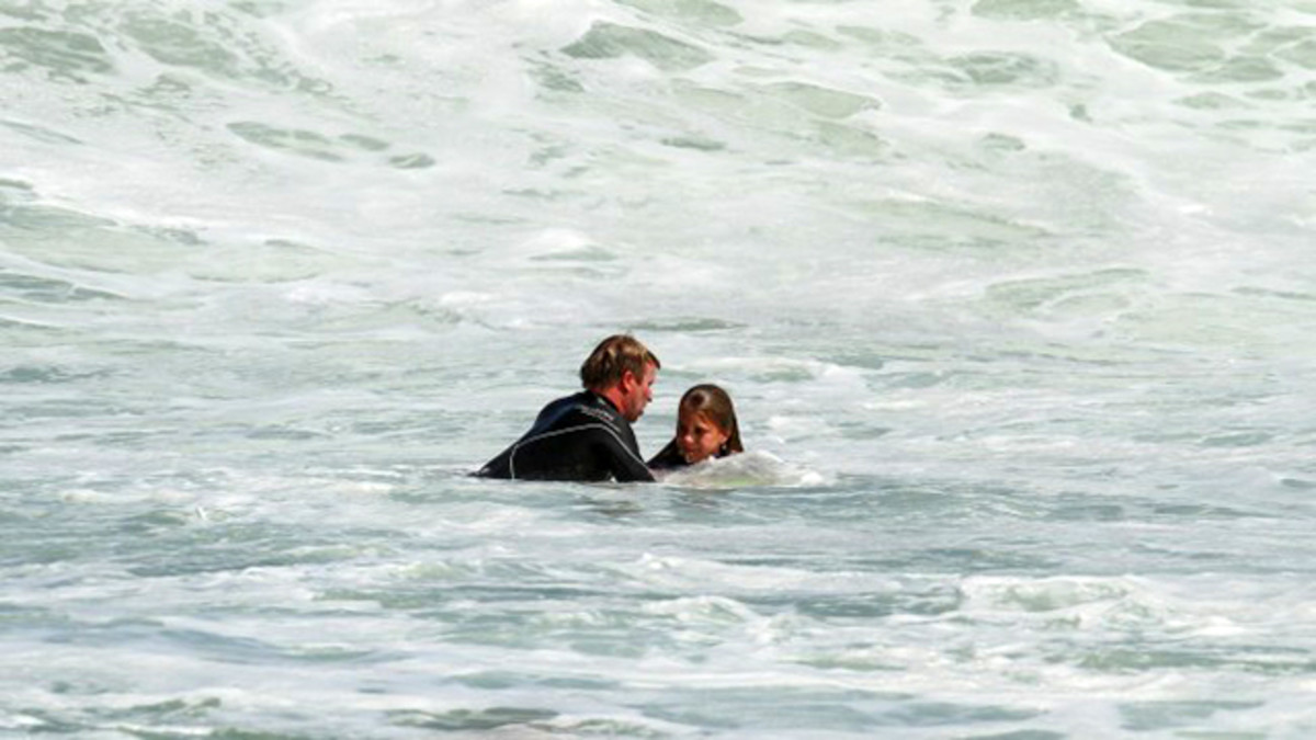 Taj Burrow coming to the aid of Chloe Campbell. Photo: Courtesy of Nick Woolacott/Surfing Western Australia