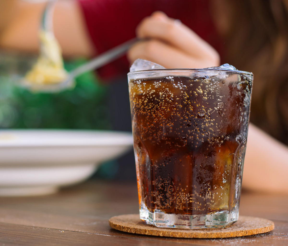 woman drinking soda in restaurant
