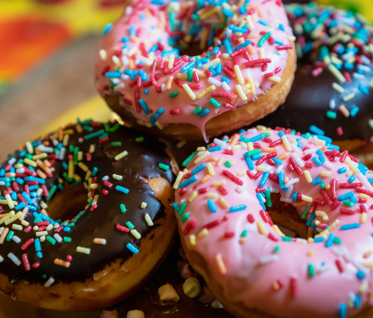an assortment of frosted doughnuts with sprinkles