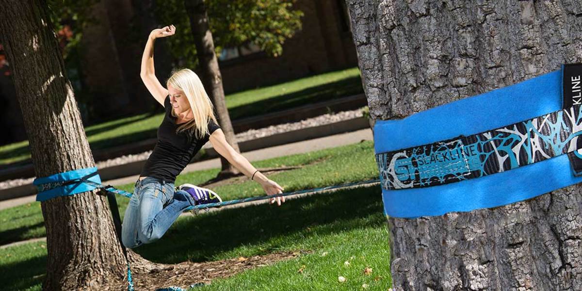 girl doing trick on slackline