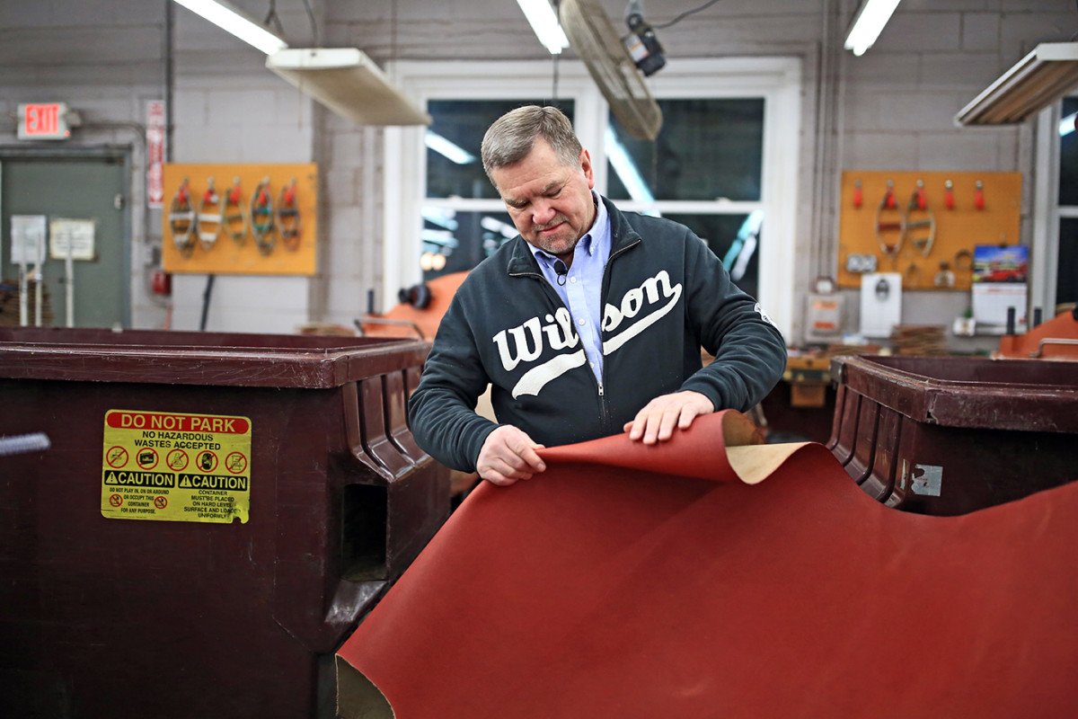 Wilson's Ada, Ohio plant manager, Dan Riegle, inspects the Horween leather that goes into the company's official Super Bowl Balls.