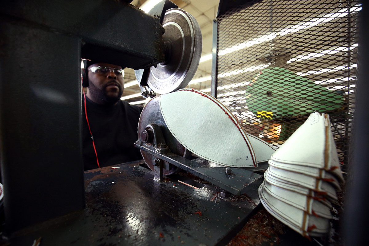 An employee of Wilson's Ada, Ohio factory sews panels of the Super Bowl balls together.