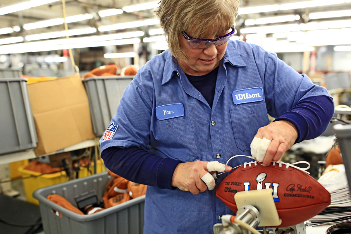Pam Boutwell, an employee at Wilson's Ada, Ohio factory, stitches one of the official Super Bowl balls.