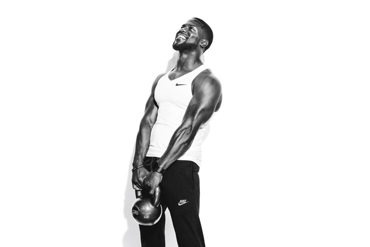 Kevin Hart posing with kettlebell on set of photoshoot