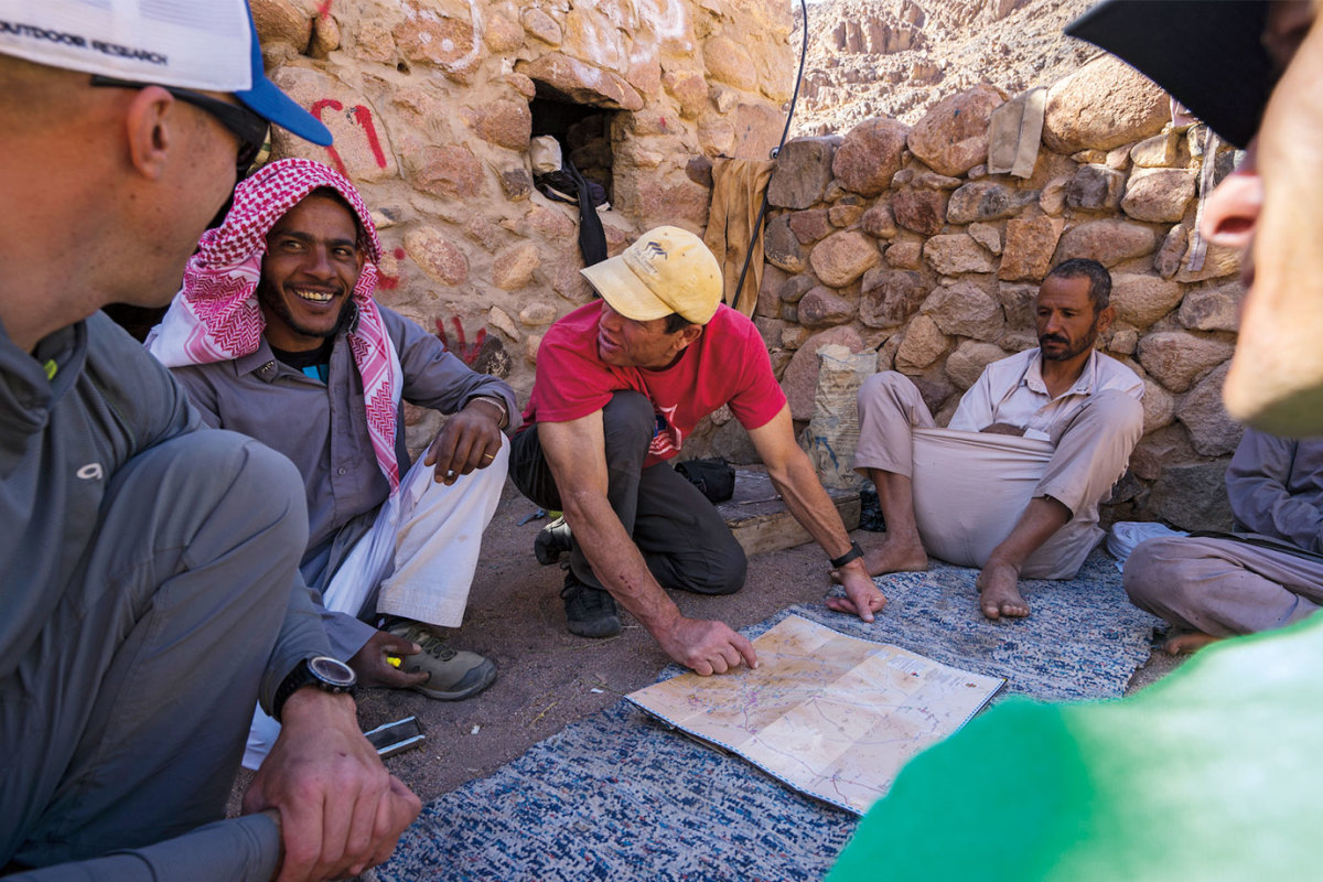 Team-looking-over-map-at-base-camp