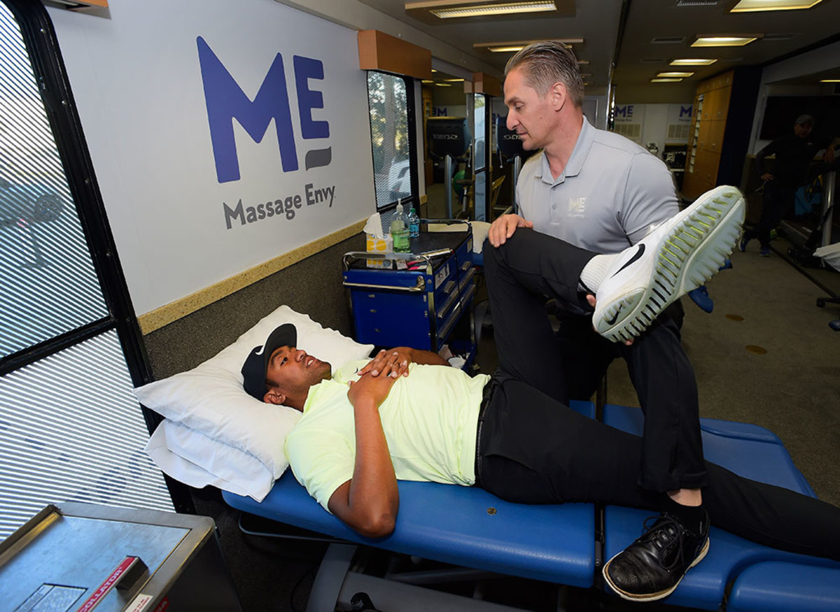 Tony Finau receives a treatment by Massage Envy Physical Therapist Jeff Hendra during the Genesis Open at Riviera Country Club on February 14, 2018 in Pacific Palisades, California.