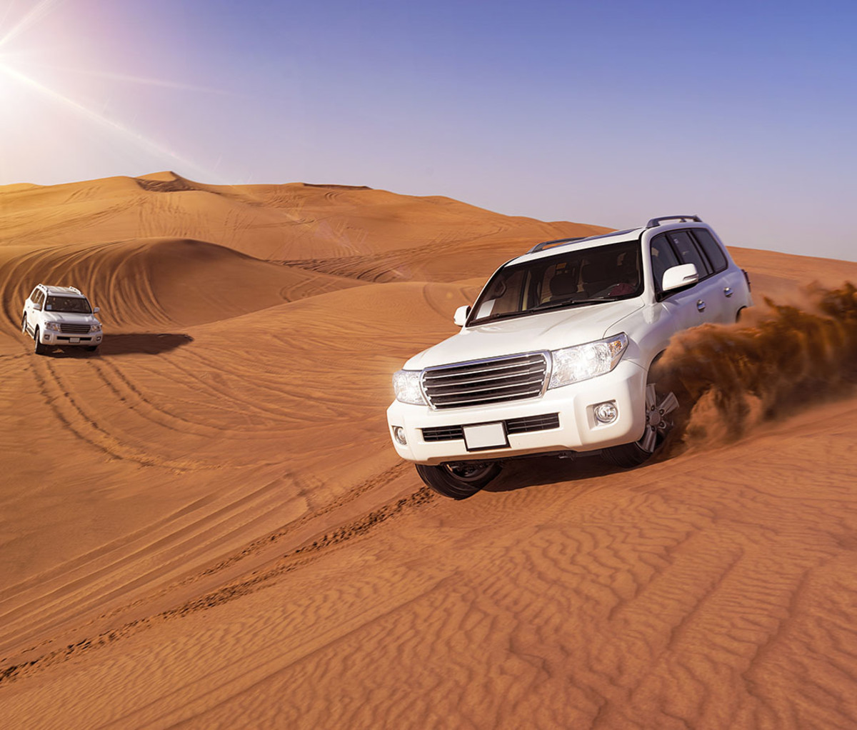 Four-wheel safari vehicles driving through the Arabian Desert