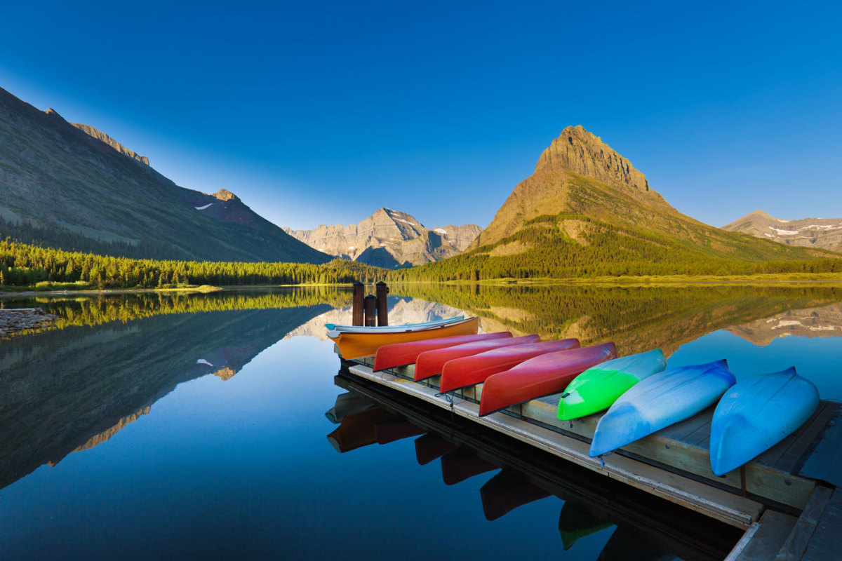A group of canoes resting at the dock deck at Many Glacier Swiftcurrent Lake at Glacier National Park