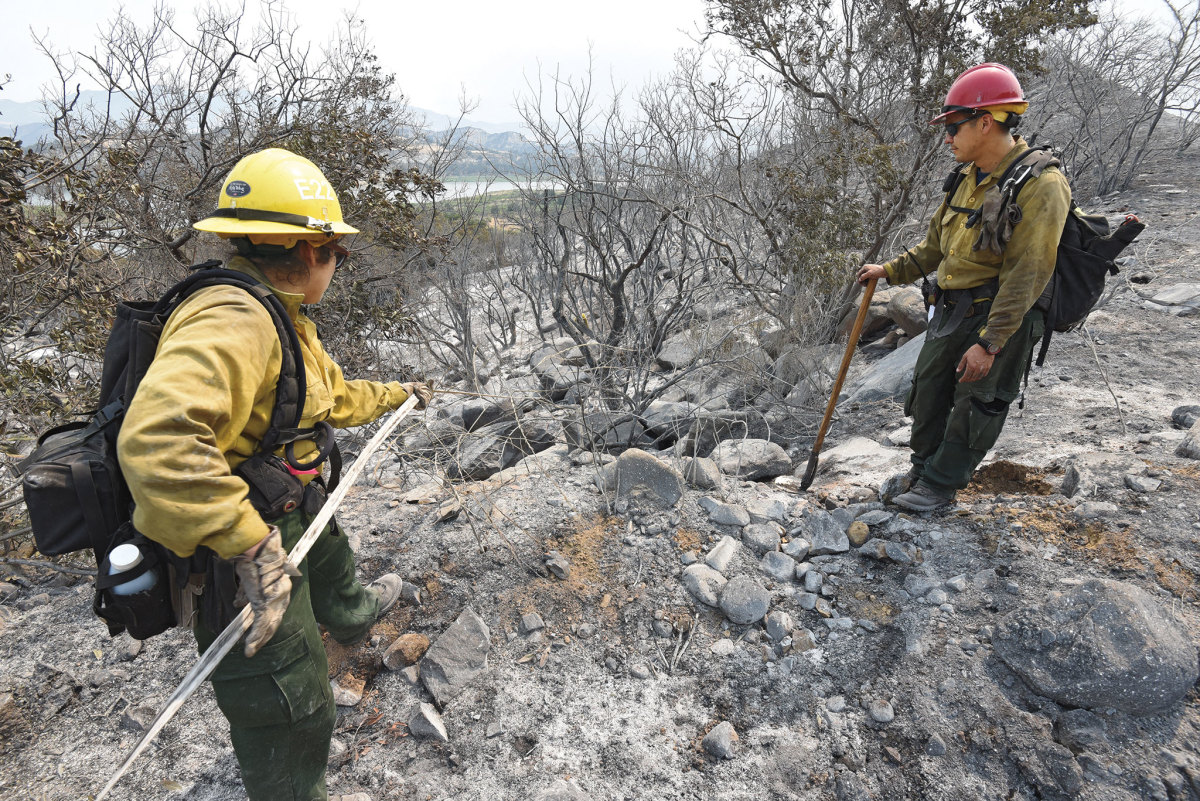 Firefighters mop up the last of the hot spots from the 2017 Whittier Fire, in Santa Barbara County, which burned more than 18,000 acres