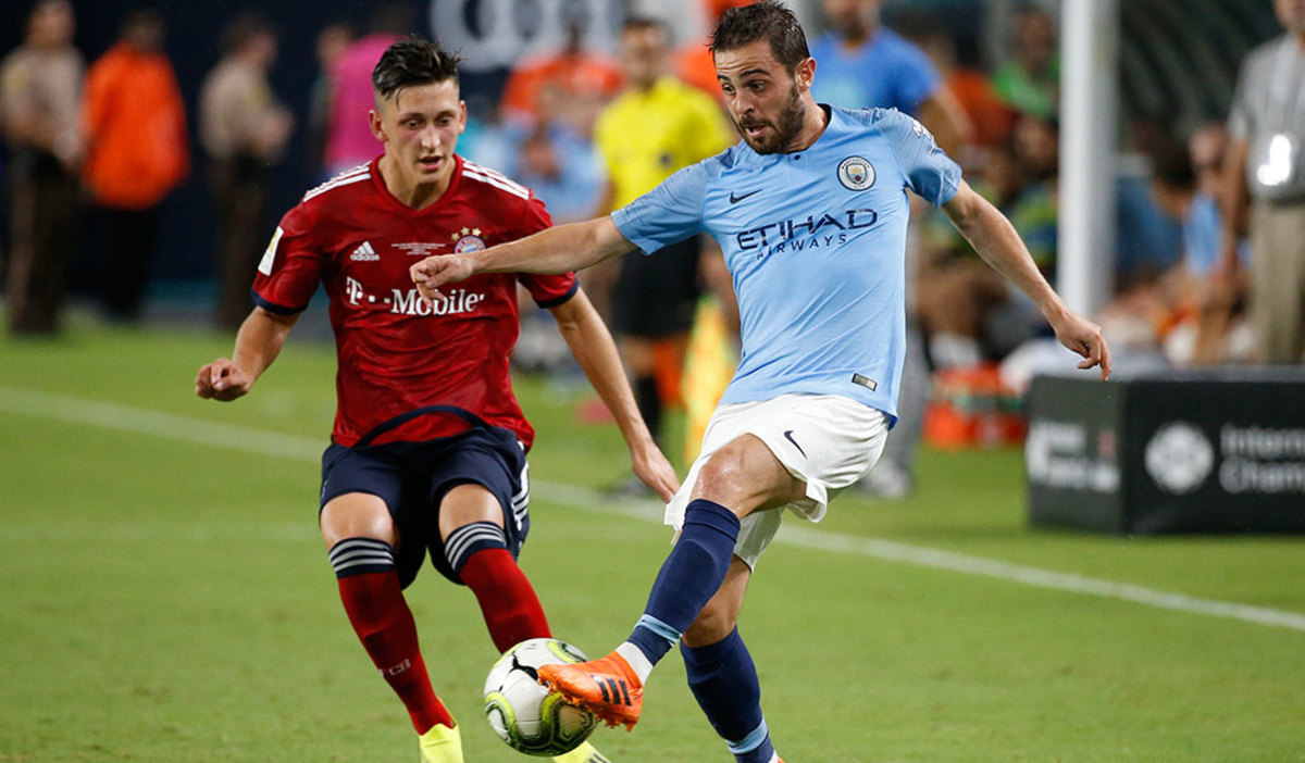 Manchester City's Portuguese midfielder Bernardo Silva (R) vies for the ball with Bayern Munich's German defense Jonathan Meier during the International Champions Cup friendly match between FC Bayern Munich and Manchester City at Hard Rock Stadium in Miami, Florida, on July 28, 2018.