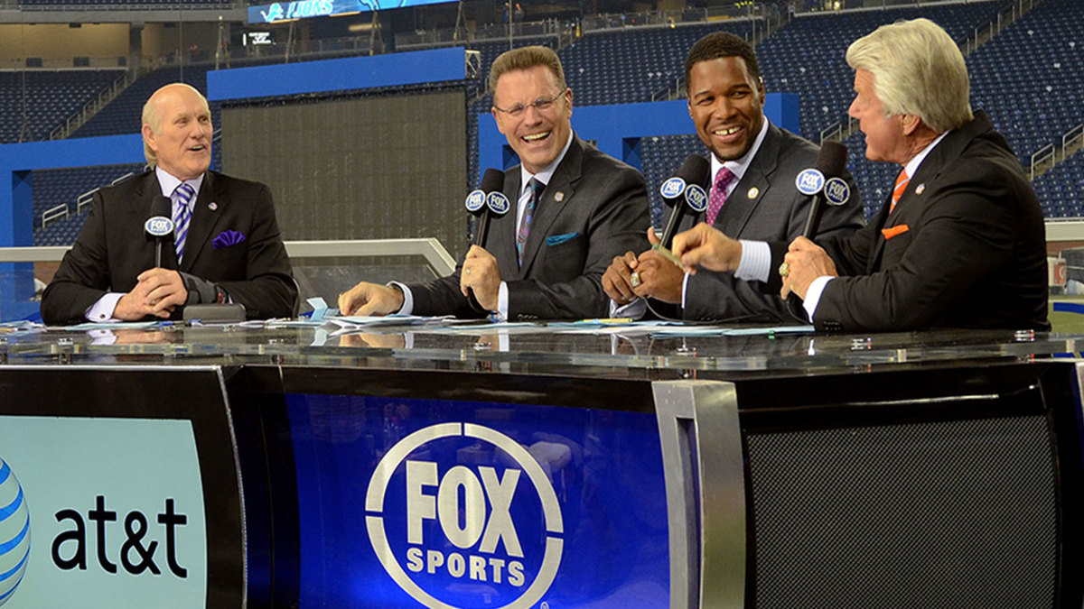 Curt Menefee, Terry Bradshaw, Howie Long, Michael Strahan and Jimmy Johnson (L-R) host the FOX television NFL Postgame Show from the sidelines after the game between the Green Bay Packers and the Detroit Lions at Ford Field on November 24, 2011 in Detroit, Michigan. The Packers defeated the Lions 27-15.