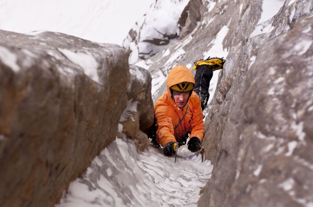 A male ice climber climbing the Ames Ice Hose,(WI5, M6) Ames, Colorado, USA